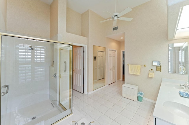 bathroom featuring vanity, independent shower and bath, tile patterned flooring, and a high ceiling