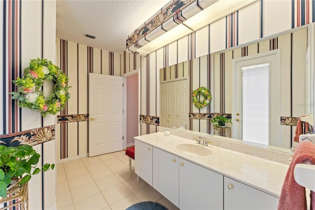 bathroom with vanity, tile patterned flooring, and a textured ceiling