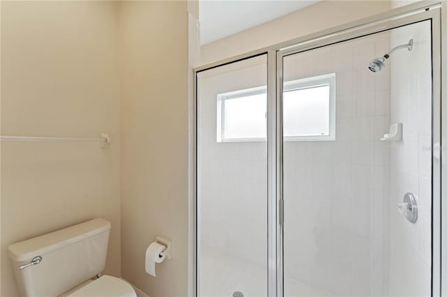 bathroom with an enclosed shower and toilet