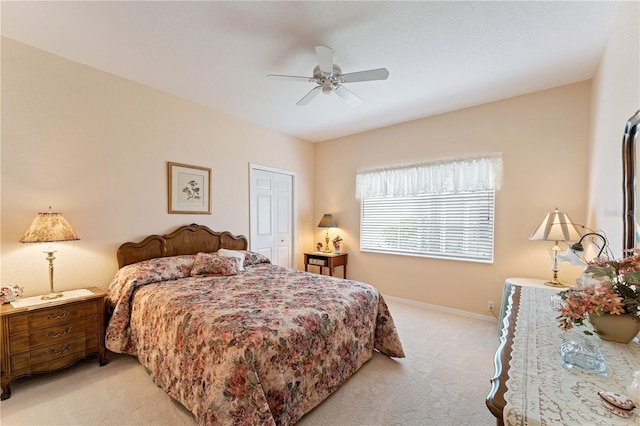 carpeted bedroom featuring a closet and ceiling fan