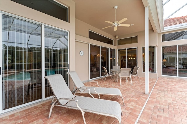 view of patio featuring a lanai and ceiling fan