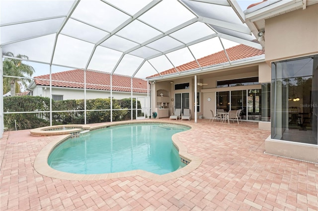 view of pool featuring an in ground hot tub, a lanai, ceiling fan, and a patio area