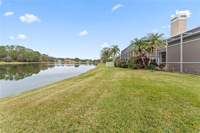 view of yard featuring a water view and a lanai