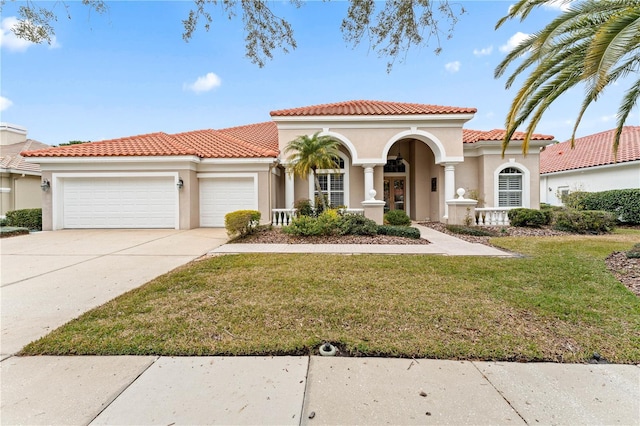 mediterranean / spanish home with a garage and a front yard