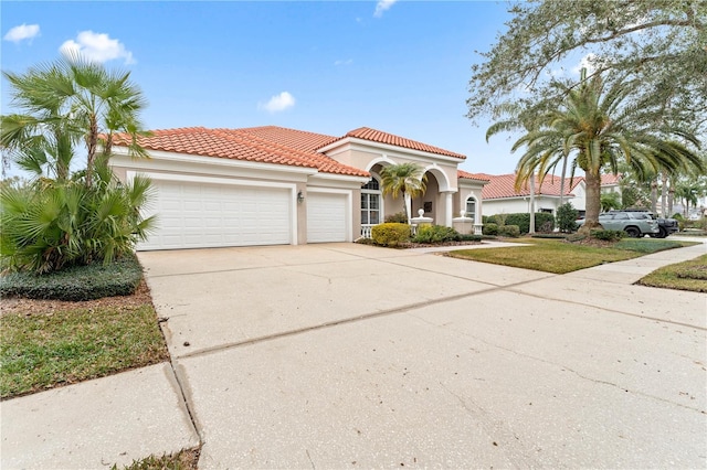 mediterranean / spanish-style house with a garage