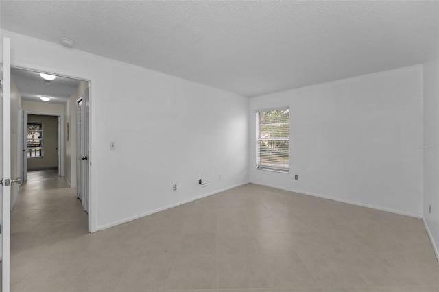 unfurnished room featuring a textured ceiling