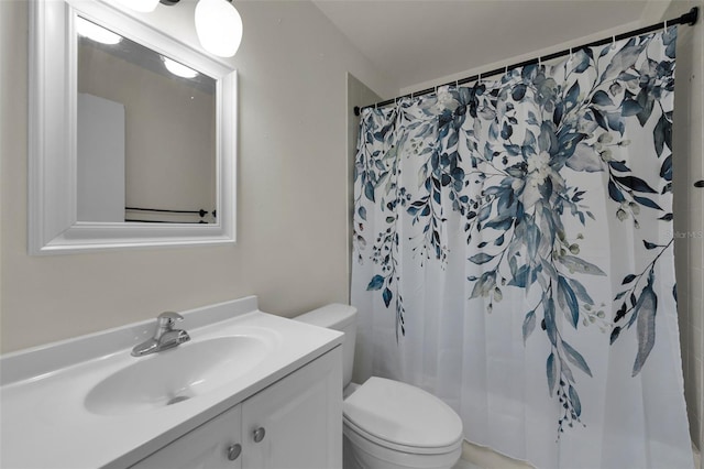 bathroom with toilet, vanity, and a shower with shower curtain