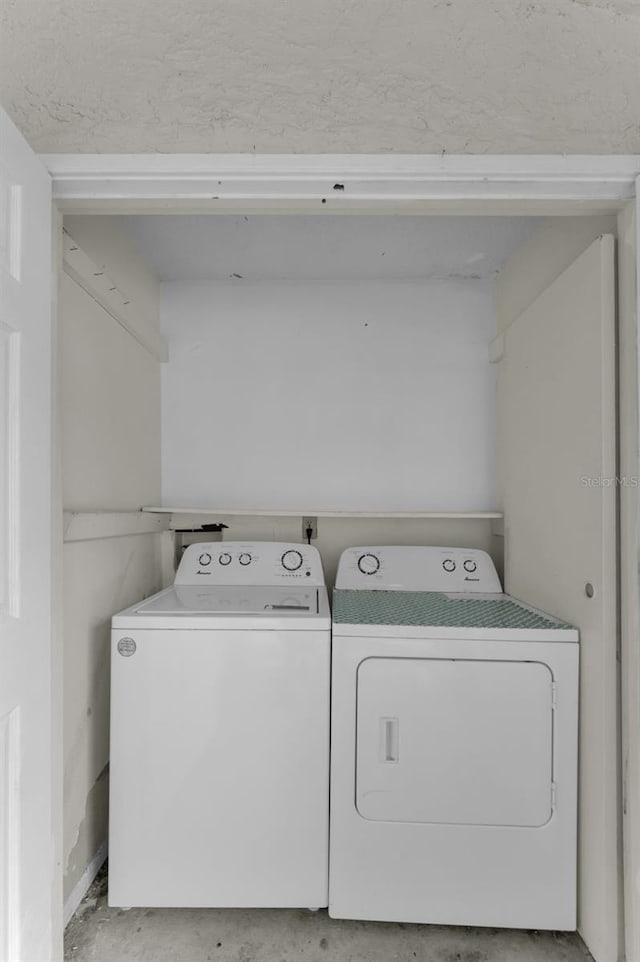 laundry area featuring washing machine and clothes dryer