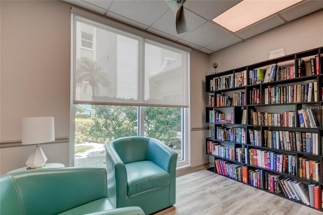 sitting room featuring a paneled ceiling and wood finished floors