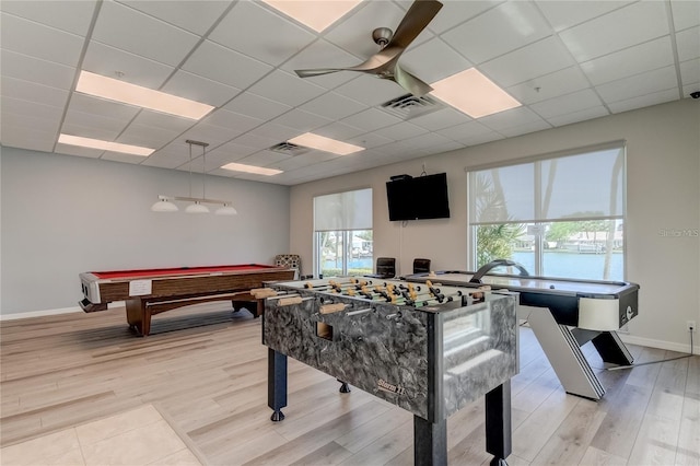 game room featuring a paneled ceiling, light wood-style flooring, visible vents, and ceiling fan