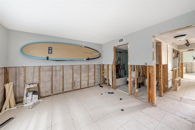 spare room with a textured ceiling