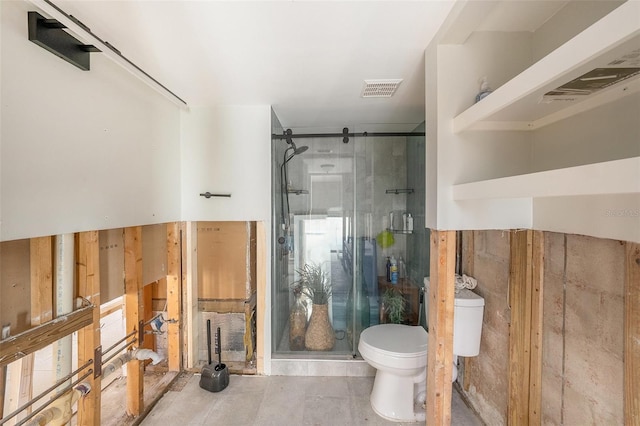 bathroom featuring toilet, concrete flooring, and a shower with shower door