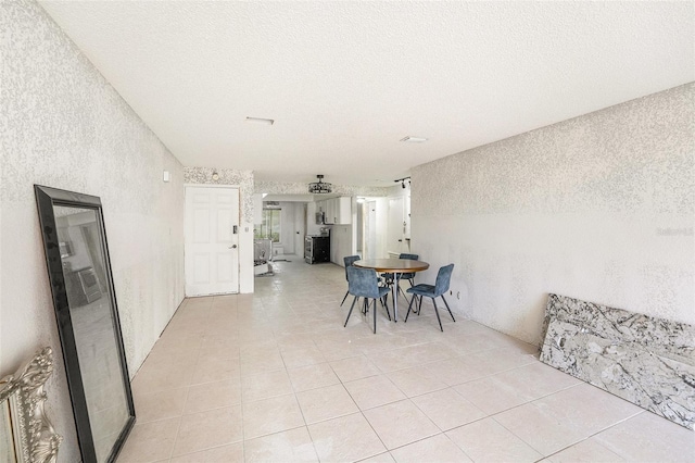 7300 Sunshine Skyway Ln S Unit 108, Saint Petersburg, FL 33711 - dining space with light tile patterned floors, a textured wall, and a textured ceiling