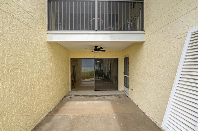7300 Sunshine Skyway Ln S Unit 108, Saint Petersburg, FL 33711 - property entrance with stucco siding, a ceiling fan, and a balcony