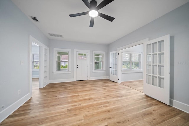 entrance foyer with ceiling fan, light hardwood / wood-style flooring, and french doors