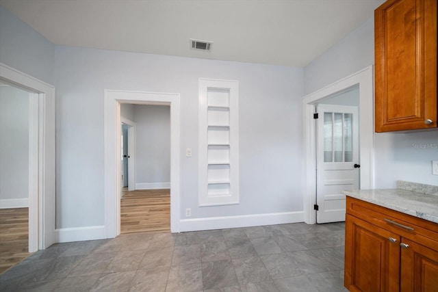 kitchen featuring light stone counters