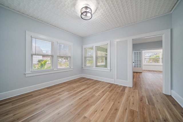 empty room with light hardwood / wood-style flooring