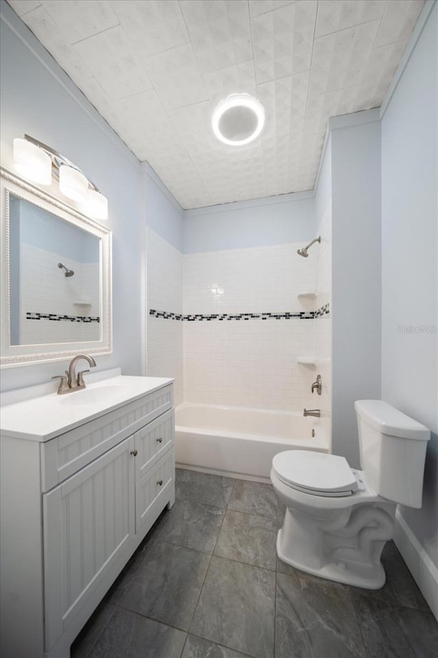 full bathroom featuring toilet, tiled shower / bath, and vanity