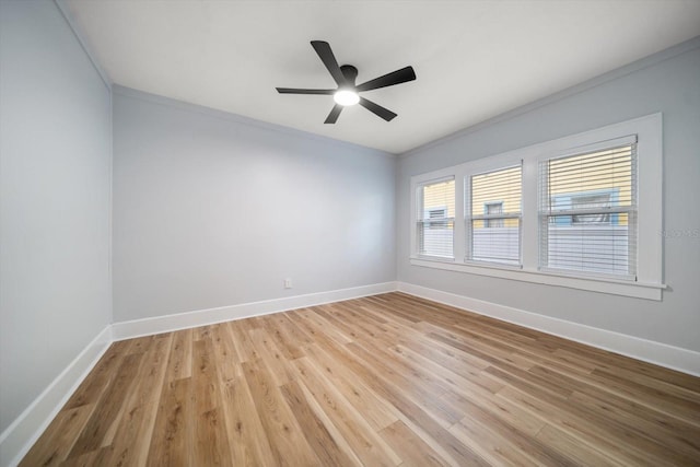 empty room featuring ceiling fan, ornamental molding, and light hardwood / wood-style floors