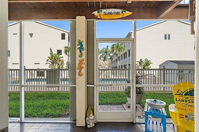 doorway to outside with wooden ceiling