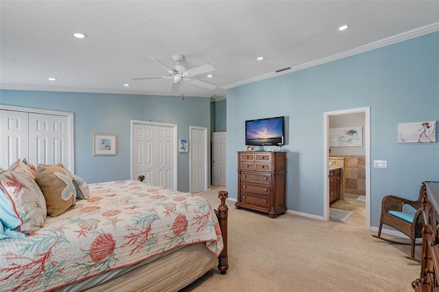 carpeted bedroom with ceiling fan, connected bathroom, ornamental molding, and multiple closets