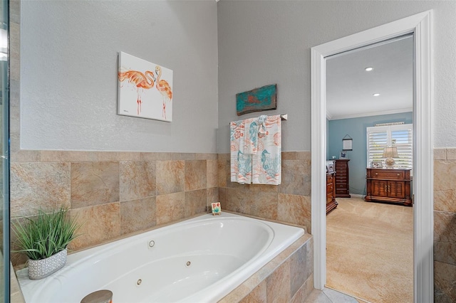 bathroom featuring tiled tub, ornamental molding, and tile patterned flooring