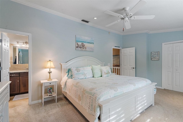 carpeted bedroom with ceiling fan, ensuite bath, a closet, and crown molding