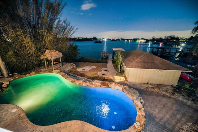 pool at dusk with a water view