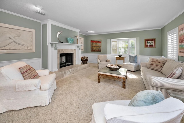 living room featuring a premium fireplace, crown molding, and carpet floors