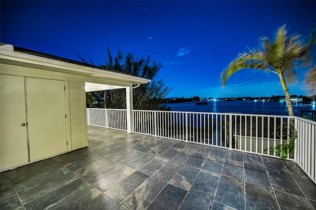 patio at night with a balcony and a water view