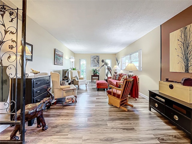 sitting room with hardwood / wood-style flooring and a textured ceiling