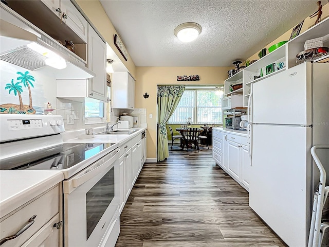 kitchen featuring sink, white cabinetry, a textured ceiling, dark hardwood / wood-style floors, and white appliances