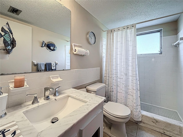 full bathroom with vanity, shower / bath combo with shower curtain, a textured ceiling, and toilet