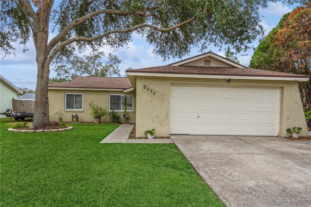 ranch-style home with a garage and a front yard