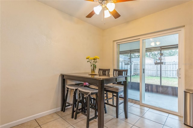 tiled dining area with ceiling fan