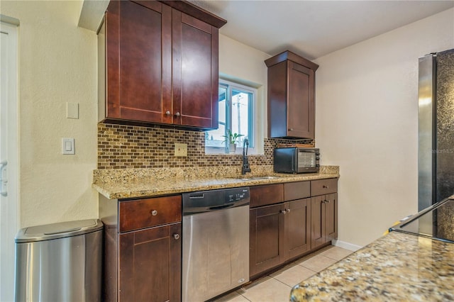 kitchen featuring light tile patterned floors, decorative backsplash, dishwasher, refrigerator, and light stone counters