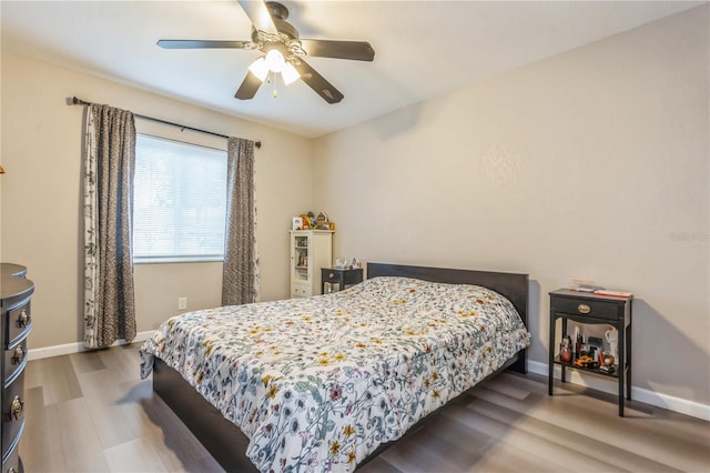 bedroom with ceiling fan and hardwood / wood-style flooring