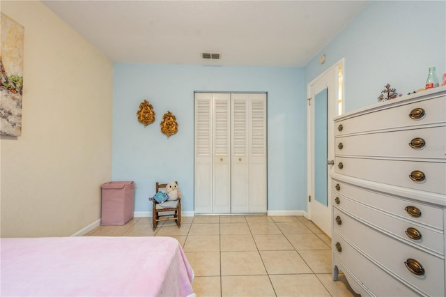 tiled bedroom featuring a closet