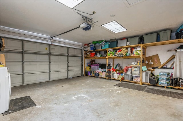 garage featuring a garage door opener and washer / clothes dryer