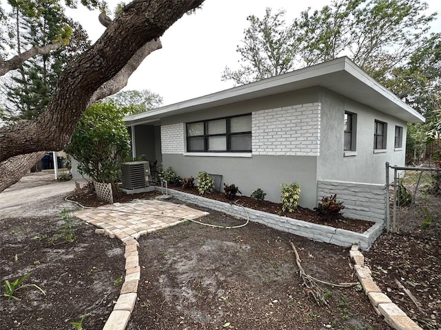 view of front facade with a patio area and cooling unit