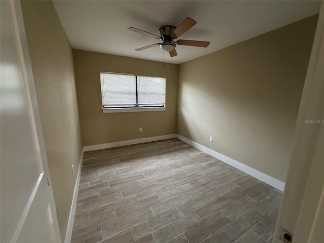 empty room with ceiling fan and light wood-type flooring