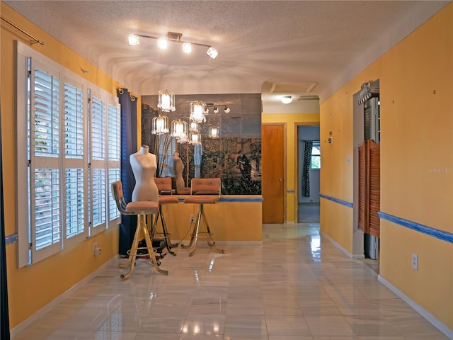 interior space with a textured ceiling