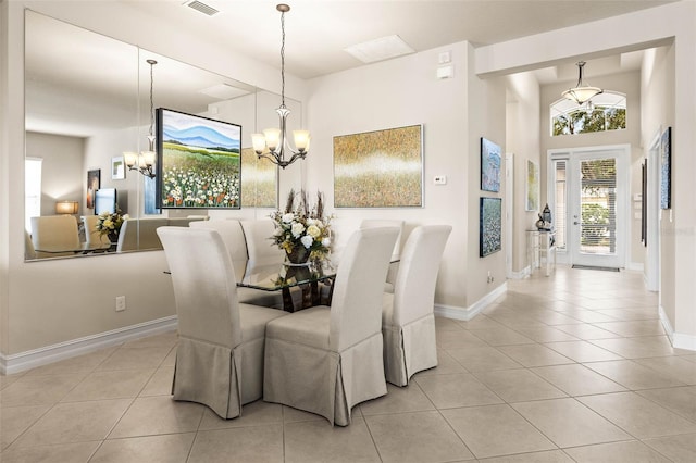 dining space featuring a notable chandelier and light tile patterned flooring