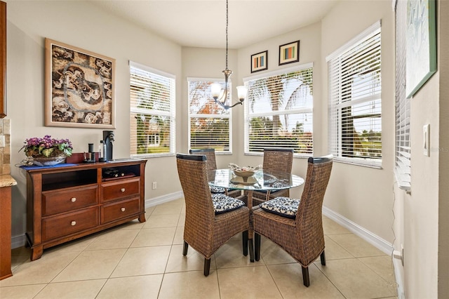 dining space featuring light tile patterned floors and a chandelier