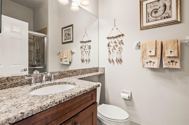 bathroom featuring toilet, walk in shower, and vanity