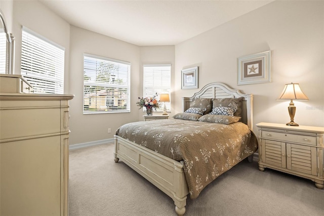 bedroom featuring light carpet