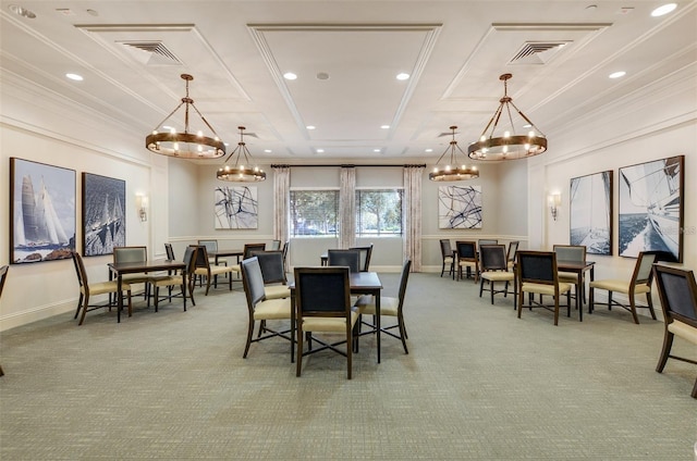 carpeted dining space featuring crown molding and an inviting chandelier