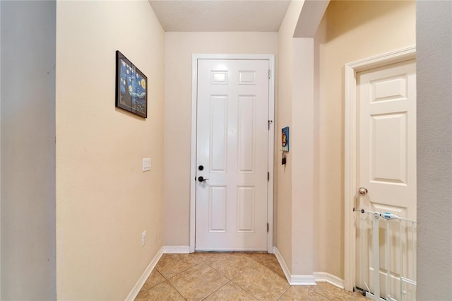 doorway to outside featuring light tile patterned flooring