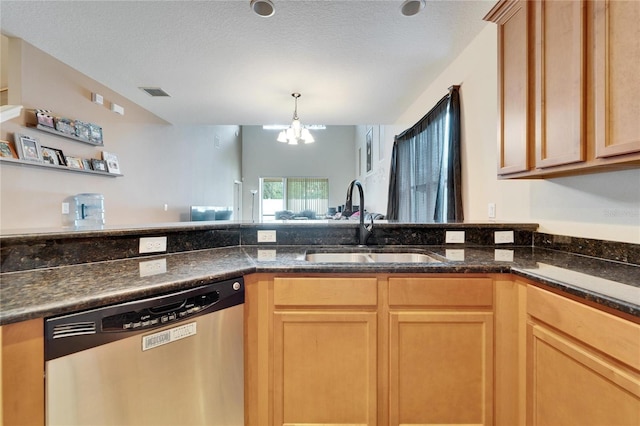 kitchen featuring a notable chandelier, dark stone countertops, stainless steel dishwasher, sink, and a textured ceiling