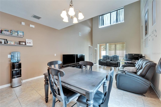 dining area with light tile patterned floors and a chandelier